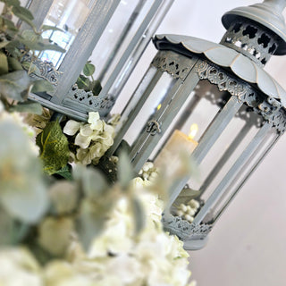 Set of 2 Heritage Lanterns from Lily Bloom with distressed grey-green finish, featuring large (H:1300mm) and small (H:1070mm) lanterns. Ideal for candles or fairy lights. Available at www.lilybloom.ie.