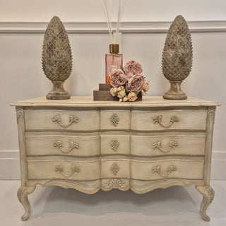 Elegant French Chic Wide 3 Drawer Chest with a classic distressed white finish and intricate detailing. Featuring three spacious drawers for ample storage, this timeless piece adds a touch of sophistication and charm to any room. Available with nationwide delivery at www.lilybloom.ie