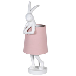 The Sofia Lamp – White rabbit table lamp with a soft pink fabric shade, adding whimsical charm and a warm glow to any space.